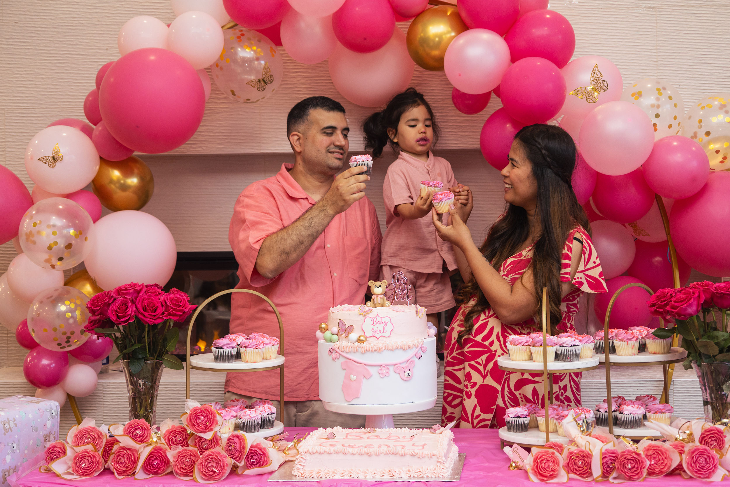 Family celebrating with the baby shower cake